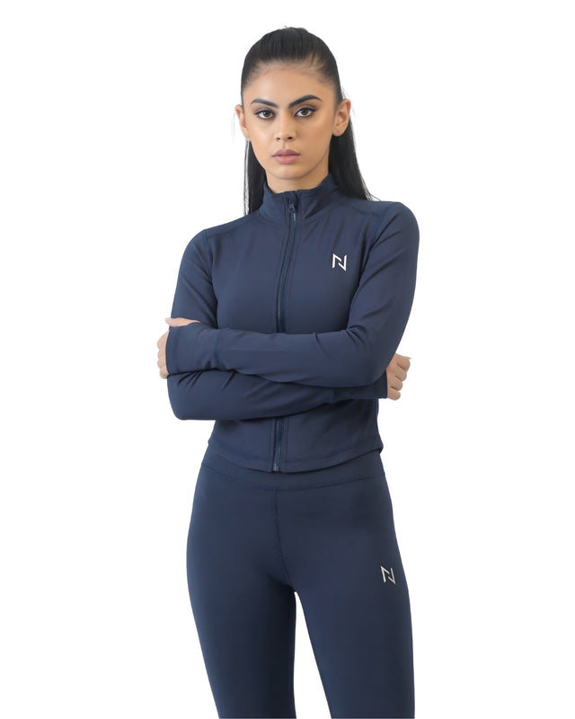 Woman wearing a navy blue athletic outfit with a brand logo on a white background