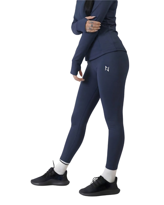 Person wearing navy leggings with a logo on a white background