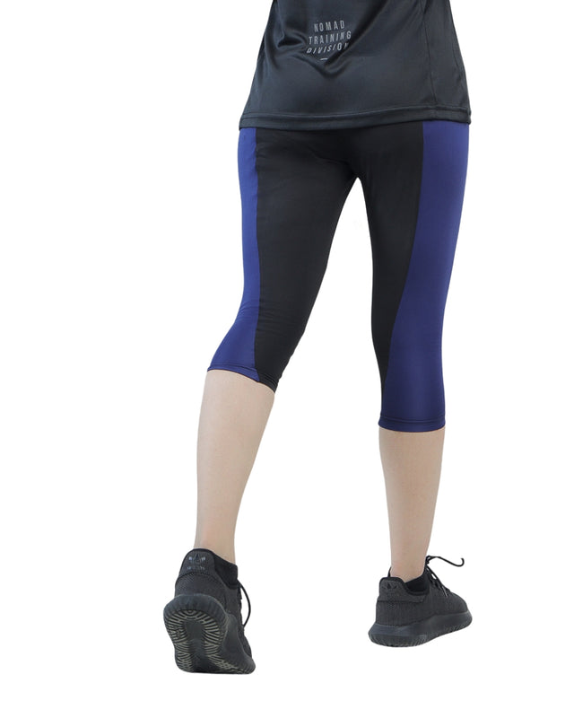 Person wearing black and blue athletic leggings on a white background