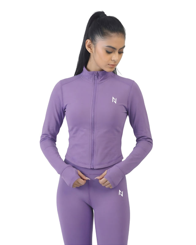 Woman wearing a purple athletic outfit with a logo on a white background