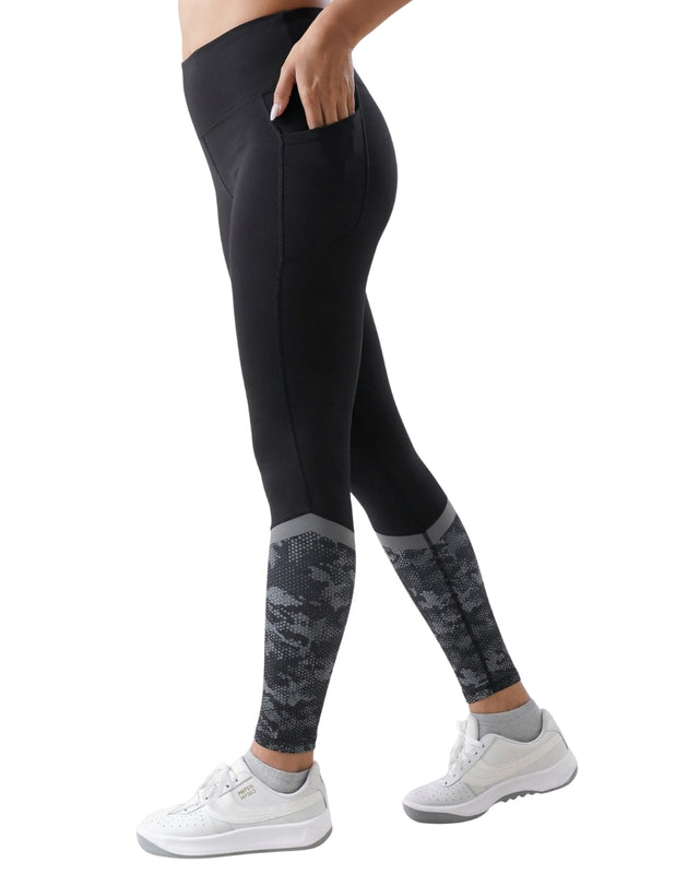 Black leggings with patterned cuffs worn by a person on a white background