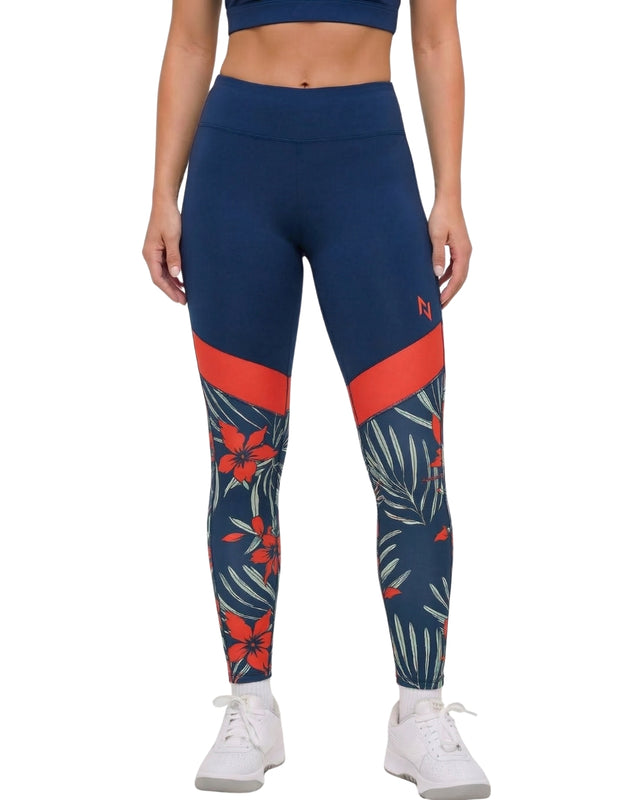 Blue leggings with red and floral pattern worn by a person on a white background