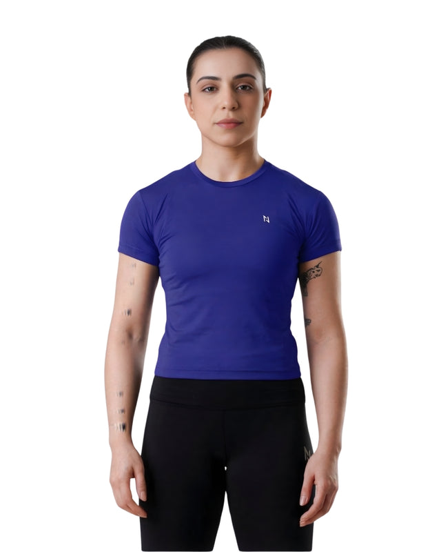 Person wearing a blue athletic shirt and black pants on a white background