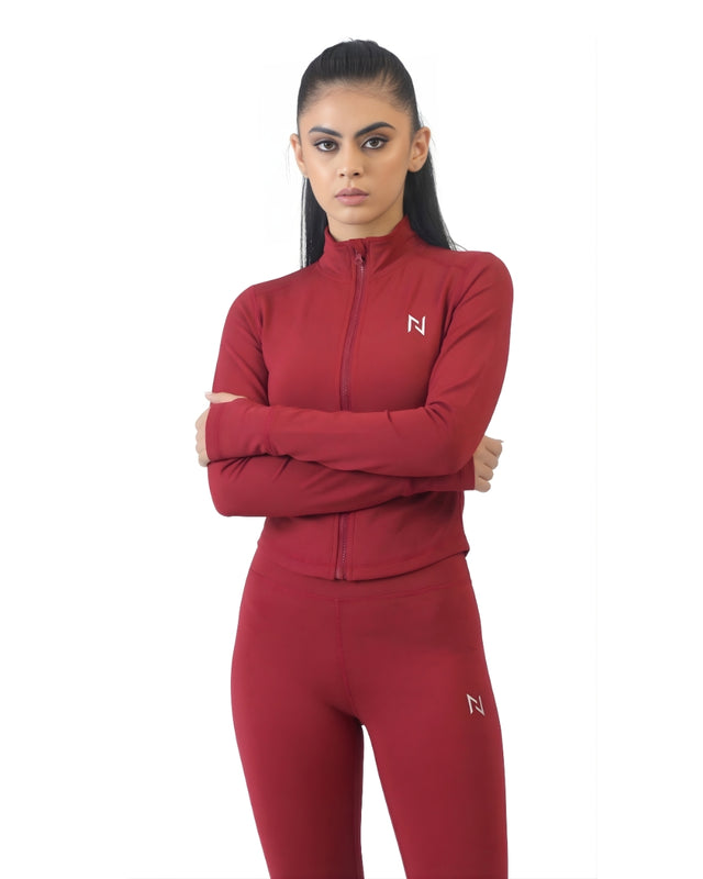 Woman wearing a red tracksuit with a logo on a white background