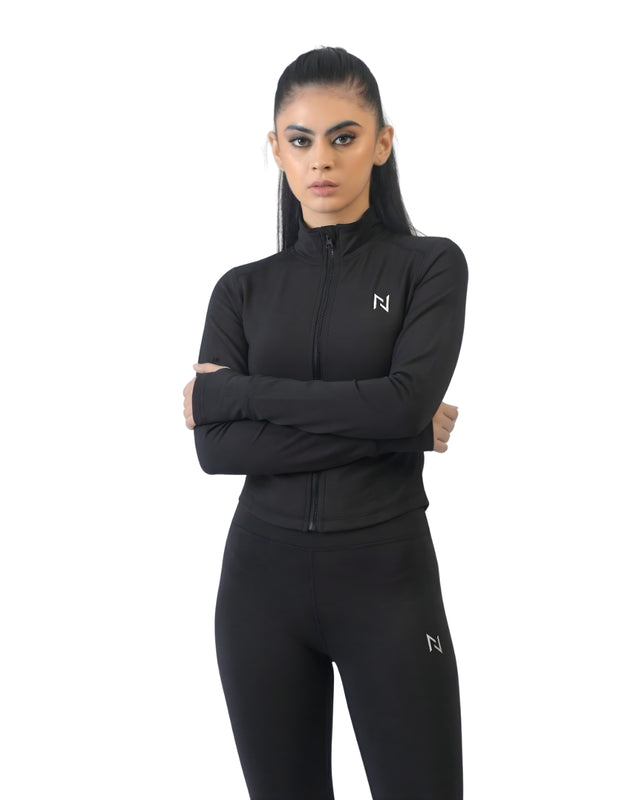 Woman wearing a black athletic outfit with a logo on a white background