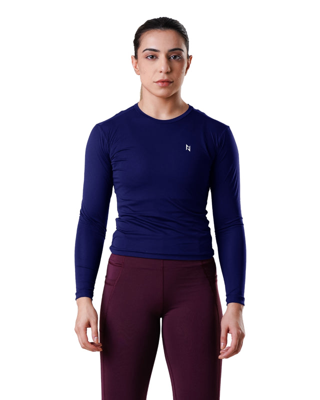 Person wearing a blue long-sleeve athletic shirt and maroon leggings on a white background