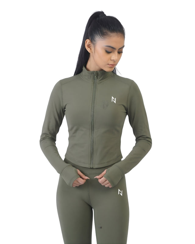 Woman wearing a green athletic outfit with a logo on a white background