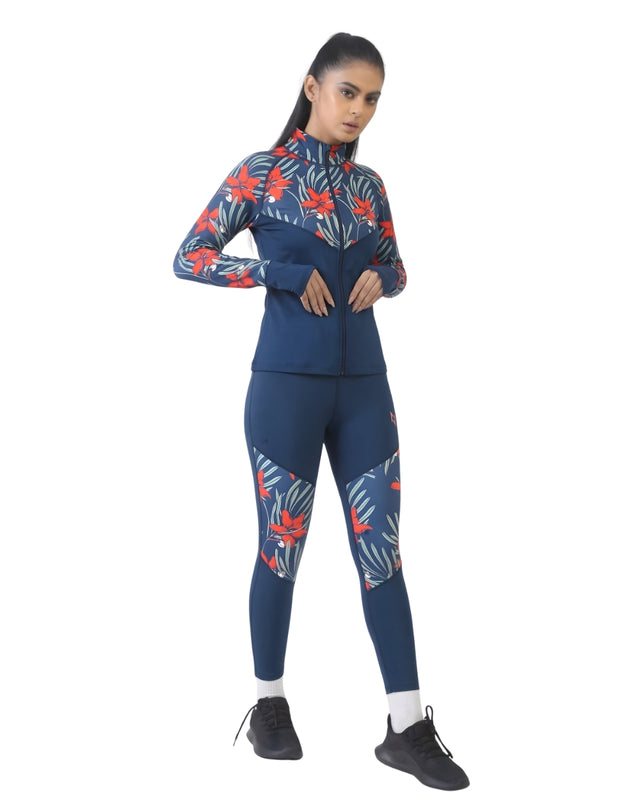 Woman wearing a blue athletic outfit with red and orange floral patterns on a white background