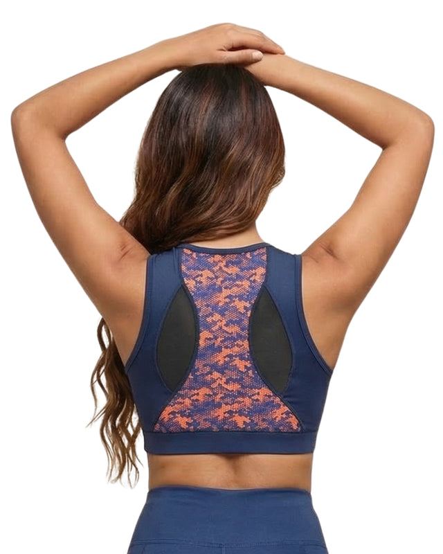 Person wearing a blue sports bra with a colorful pattern on a white background