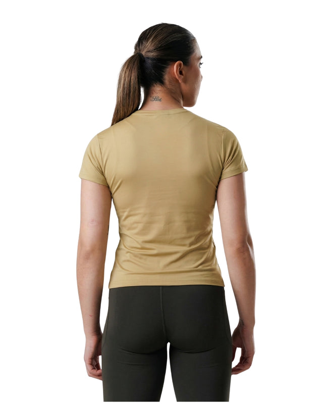 Person wearing a beige t-shirt and black leggings on a white background