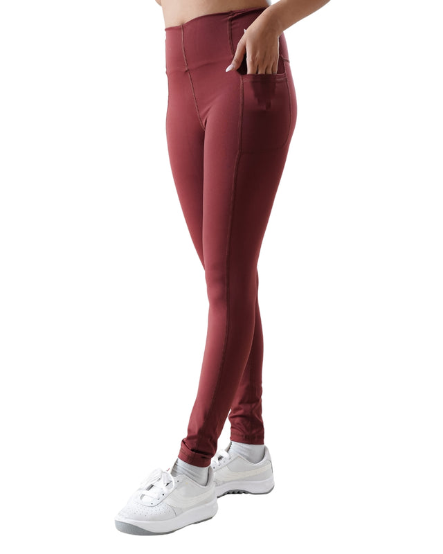 Maroon leggings worn by a person on a white background