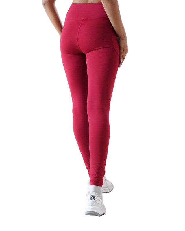 Red leggings worn by a person on a white background