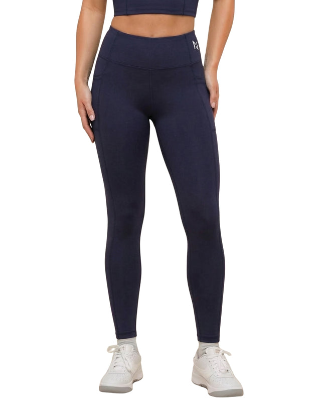 Navy leggings worn by a person on a white background