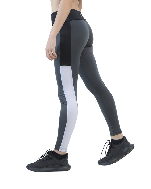 Person wearing gray leggings with white stripe on a white background