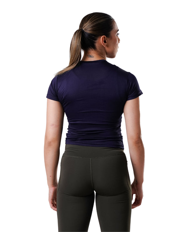 Person wearing a dark blue athletic shirt and black leggings on a white background