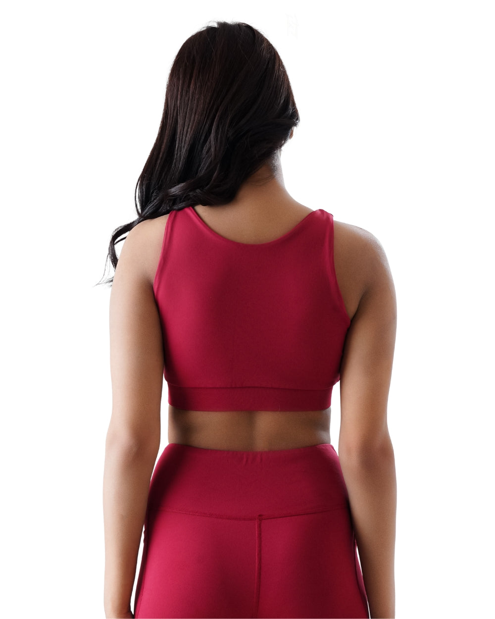 Person wearing a red crop top and pants on a white background