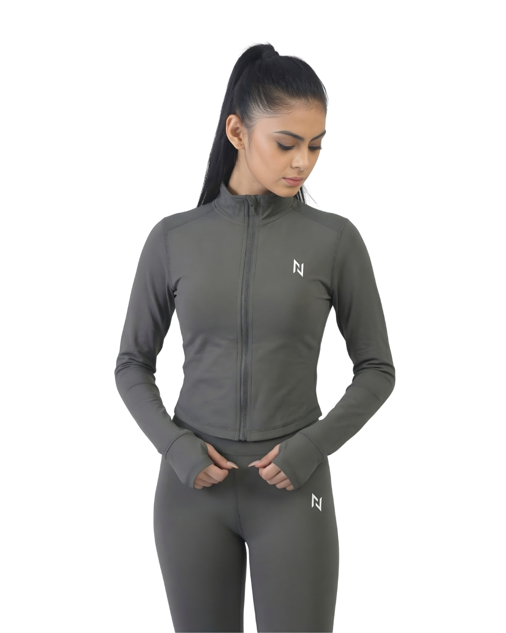 Woman wearing a gray athletic jacket and leggings with a brand logo on a white background