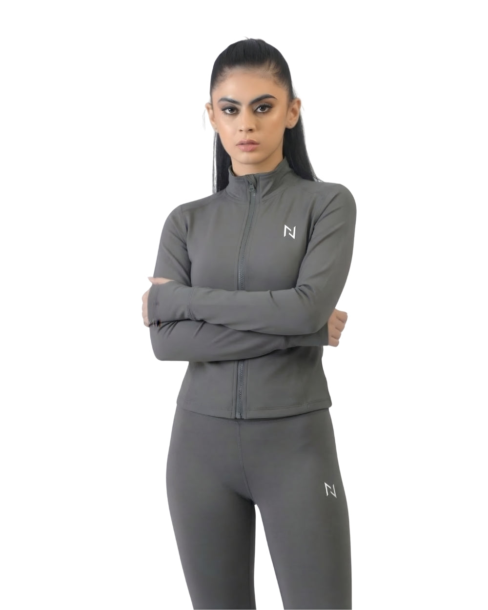Woman wearing a gray athletic outfit with a brand logo on a white background