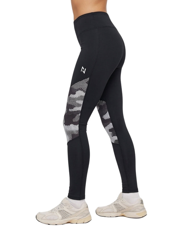 Black athletic leggings with gray mesh panels worn by a person on a white background