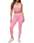 Woman wearing a pink sports bra and leggings set on a white background
