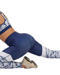 Blue athletic leggings with white camouflage patterns on a white background