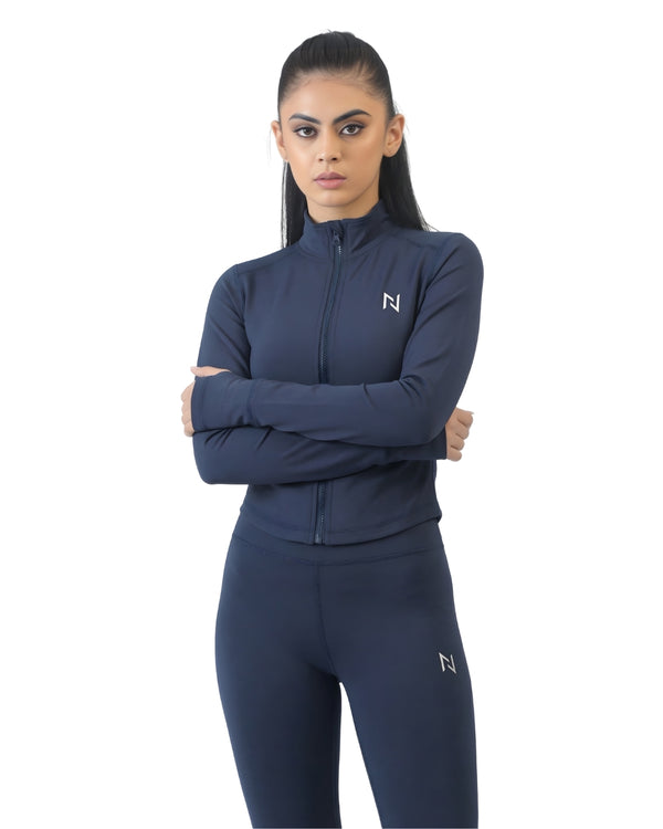 Woman wearing a navy blue athletic outfit with a brand logo on a white background