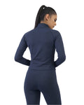 Woman wearing a navy blue athletic outfit on a white background
