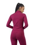 Person wearing a magenta athletic outfit on a white background