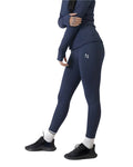 Person wearing navy leggings with a logo on a white background