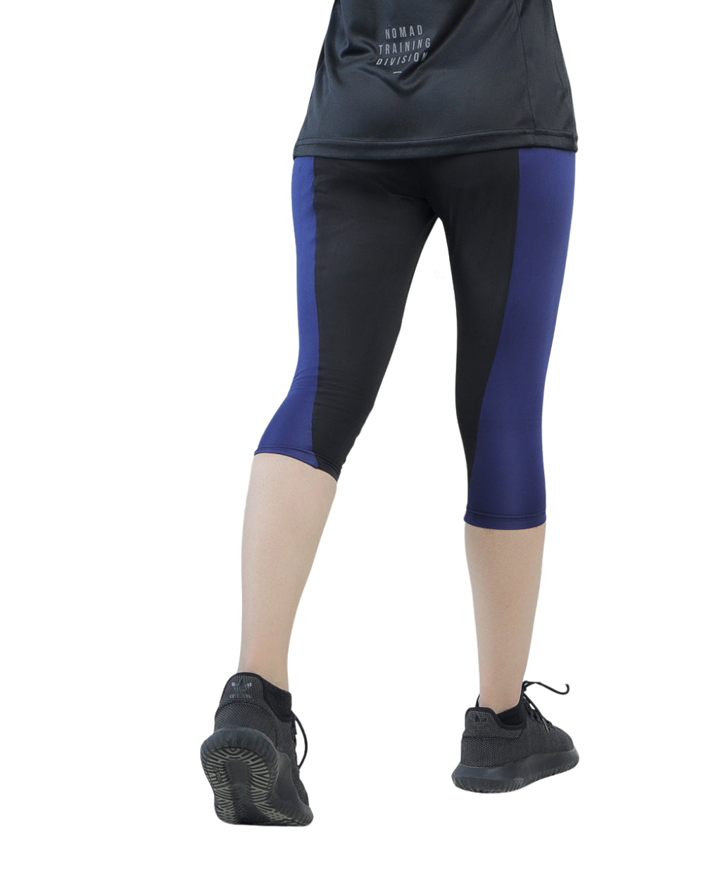 Person wearing black and blue athletic leggings on a white background
