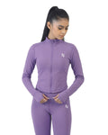 Woman wearing a purple athletic outfit with a logo on a white background