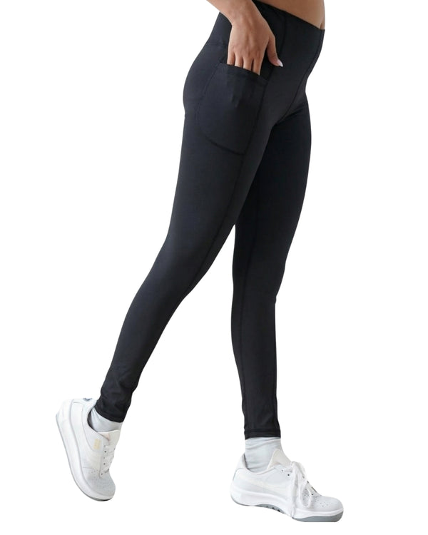 Person wearing black leggings with a white background