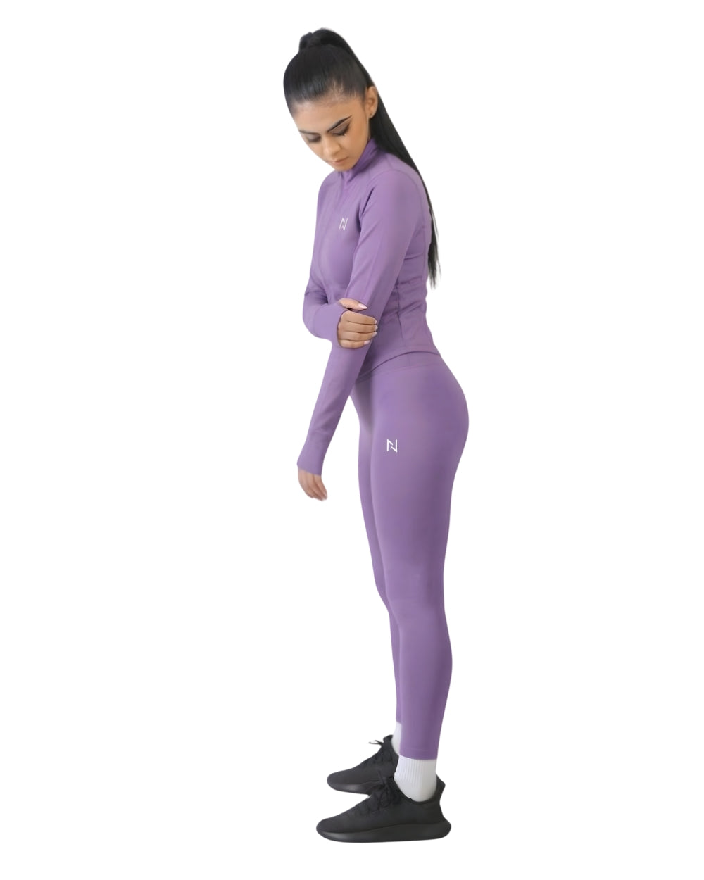 Woman wearing a purple athletic outfit with a logo on a white background