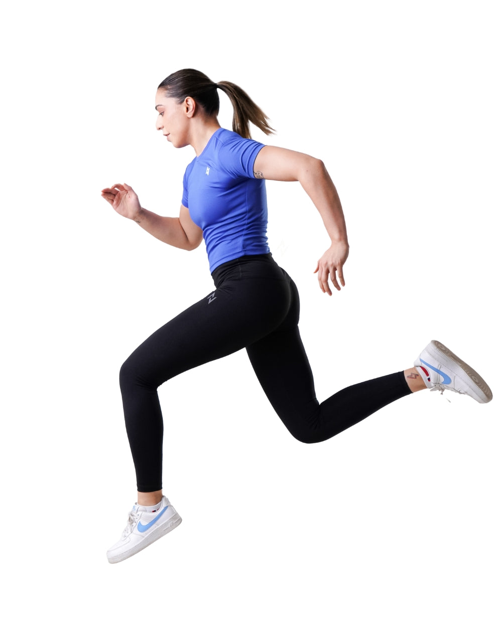 Woman running in athletic wear on a white background