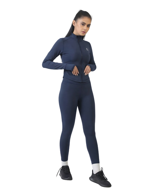 Woman wearing a navy blue athletic outfit on a white background