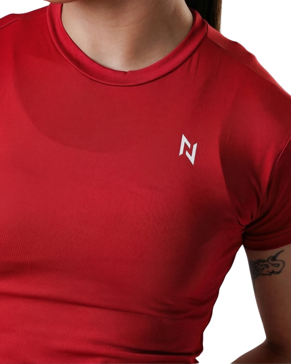 Red athletic shirt with a logo on a white background