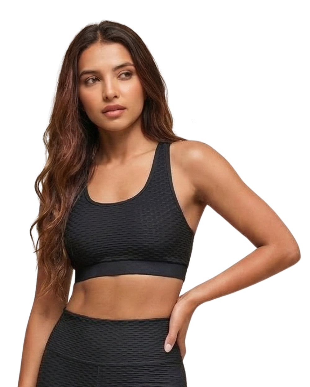 Woman wearing a black sports bra and leggings on a white background