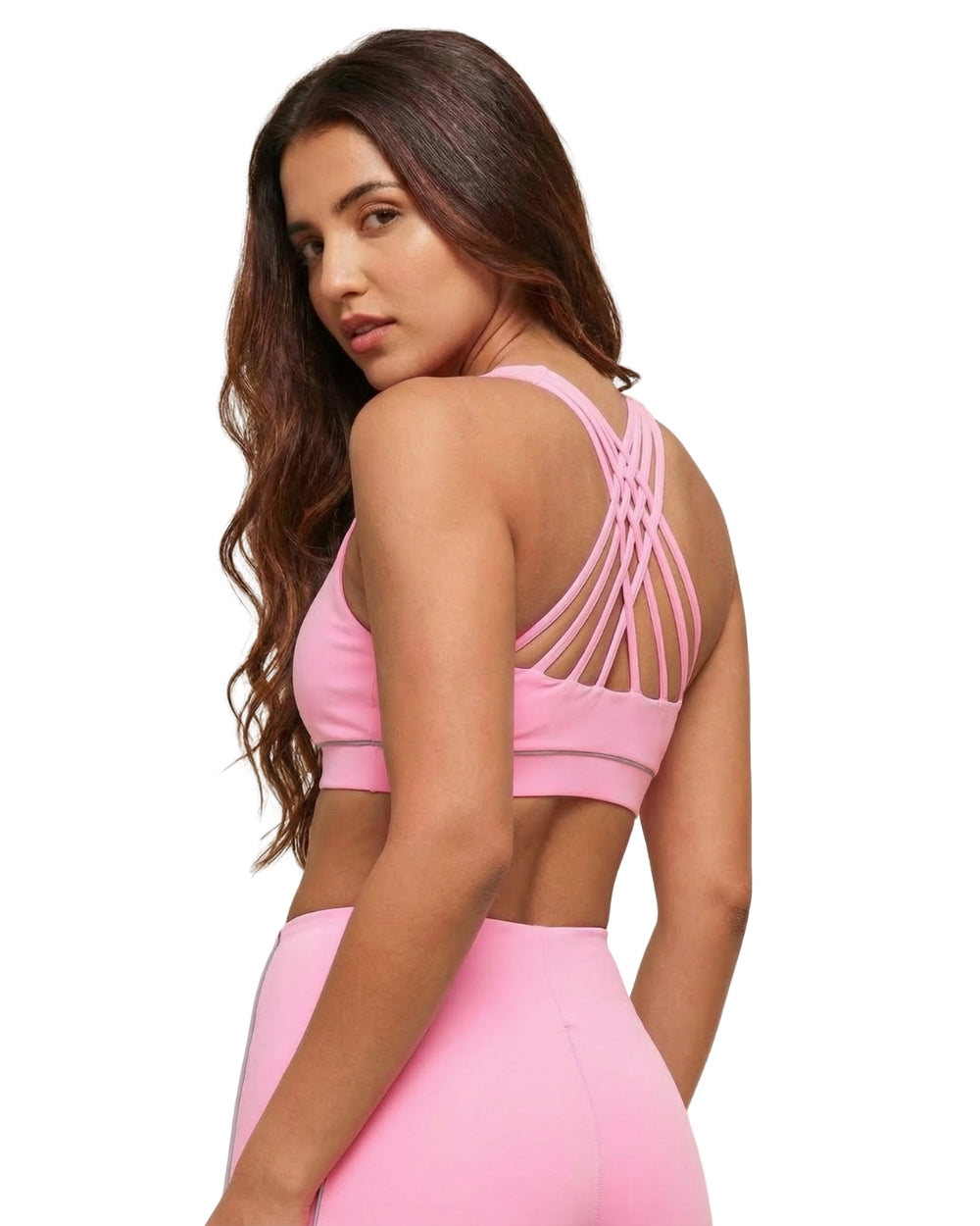 Woman wearing a pink sports bra and leggings on a white background