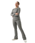Woman wearing a gray tracksuit on a white background