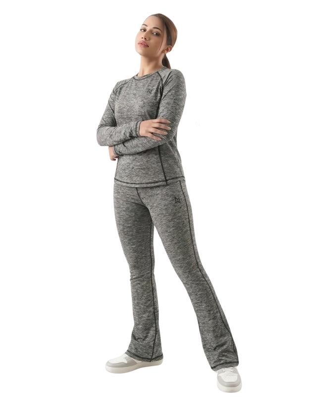 Woman wearing a gray tracksuit on a white background