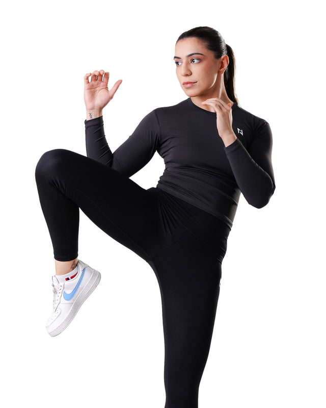 Woman in black athletic wear with a white background