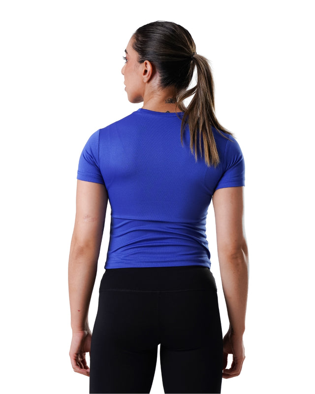 Person wearing a blue athletic shirt and black leggings on a white background