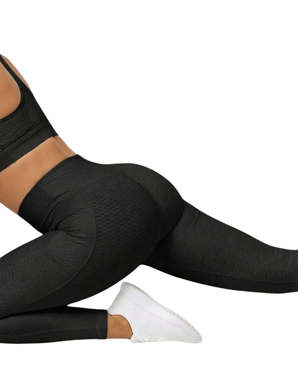 Person wearing black leggings and white shoes on a white background