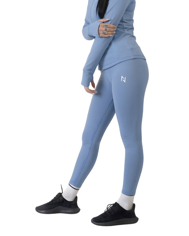 Person wearing a blue athletic outfit with a logo on a white background