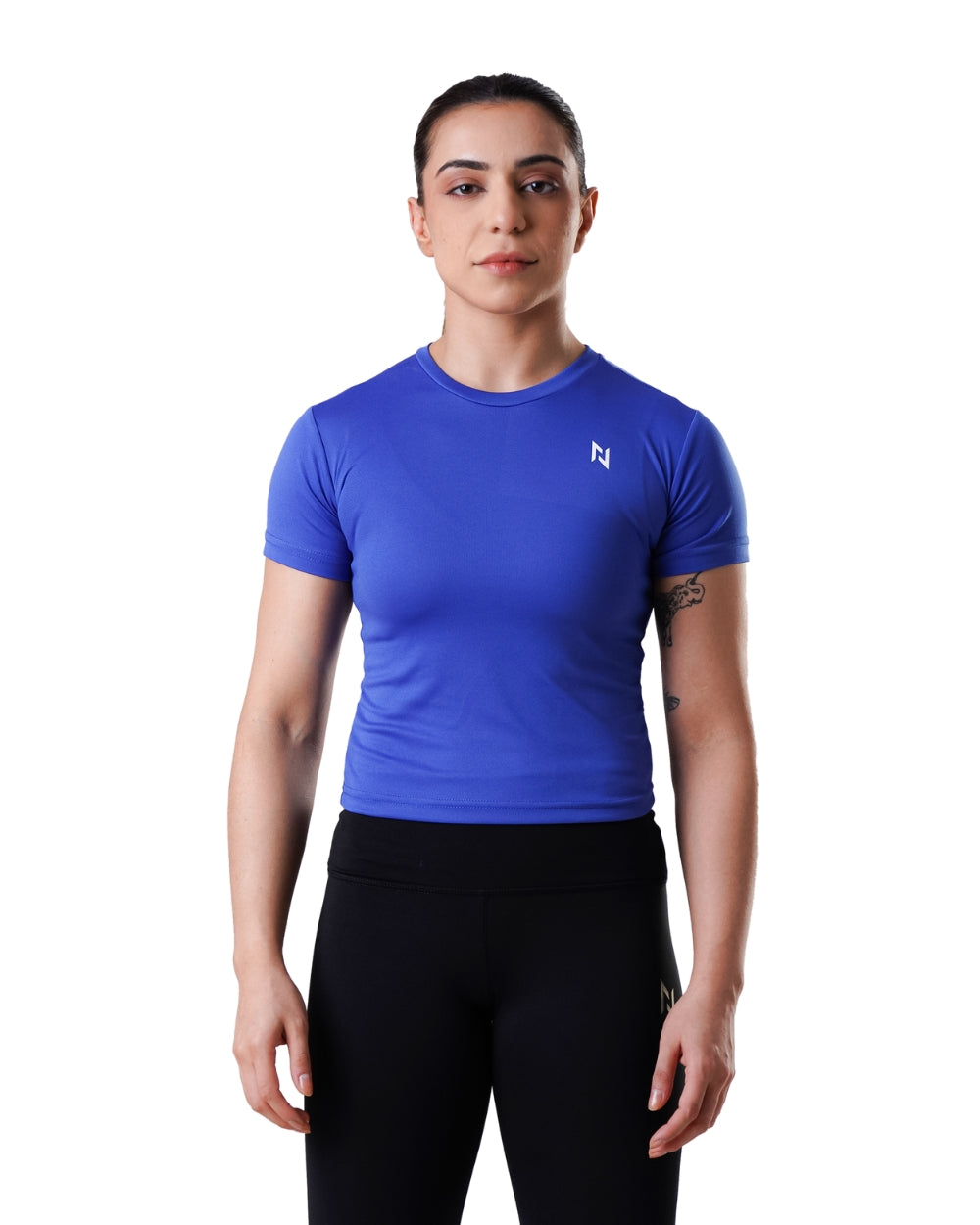 Person wearing a blue athletic shirt with a logo on a white background