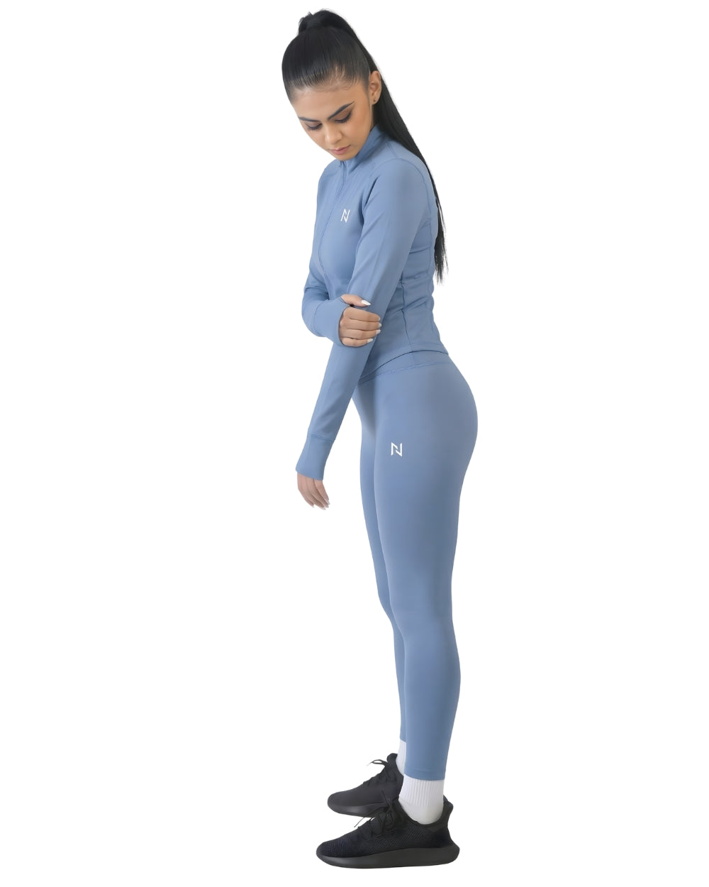 Woman wearing a blue athletic outfit with a logo on a white background