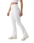 Person wearing white flared pants on a white background