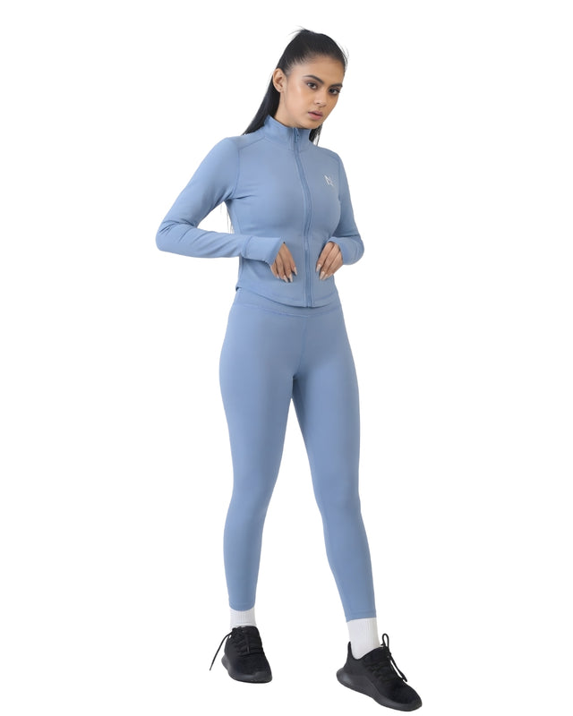 Woman wearing a blue athletic outfit on a white background