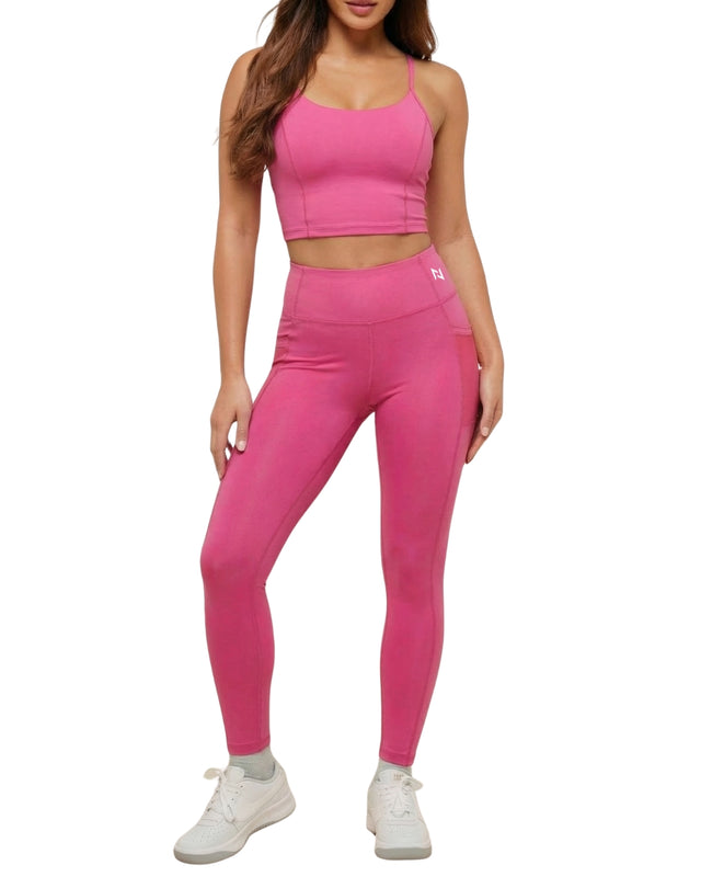 Person wearing a pink athletic outfit on a white background