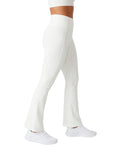 White leggings worn by a person on a white background